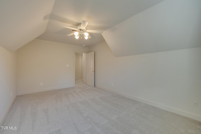 bonus room with vaulted ceiling, light colored carpet, and ceiling fan