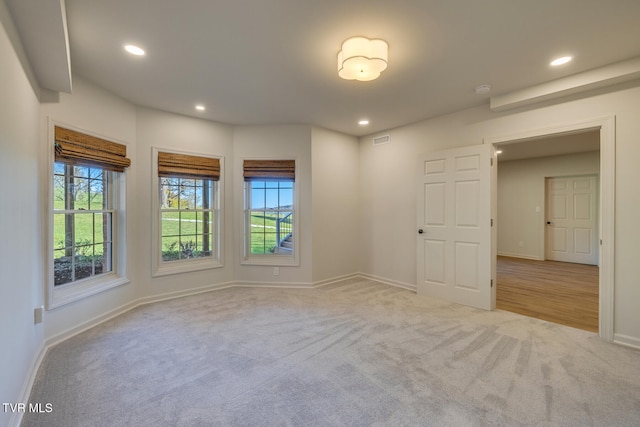 unfurnished room featuring light colored carpet