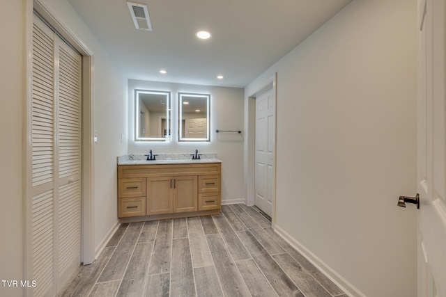 bathroom with vanity and hardwood / wood-style flooring