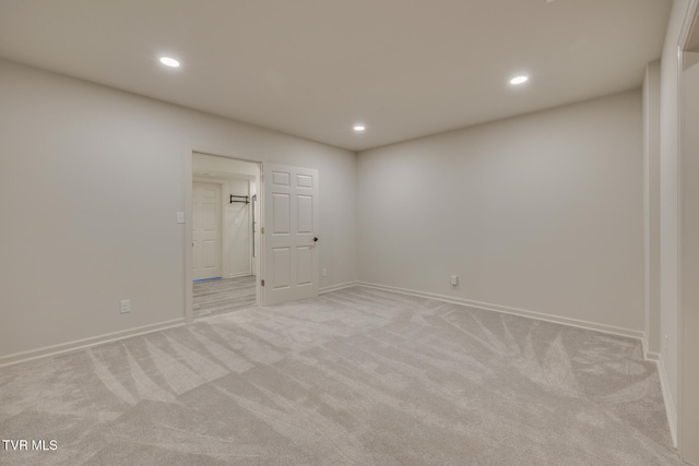 unfurnished room featuring light carpet