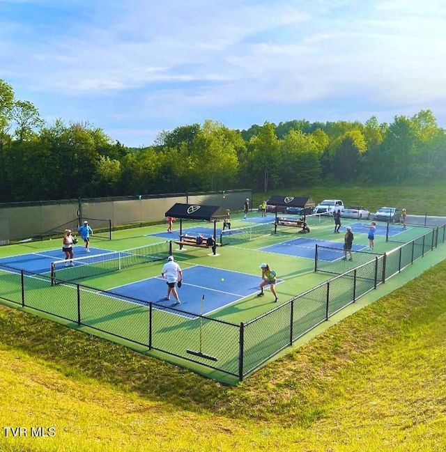 view of tennis court with a lawn