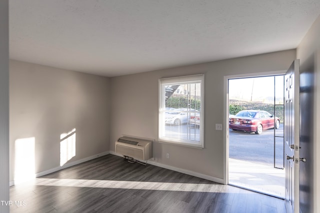 entryway with dark wood-type flooring and a wall mounted air conditioner