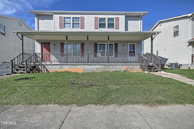 view of front of house with a front yard, cooling unit, and covered porch