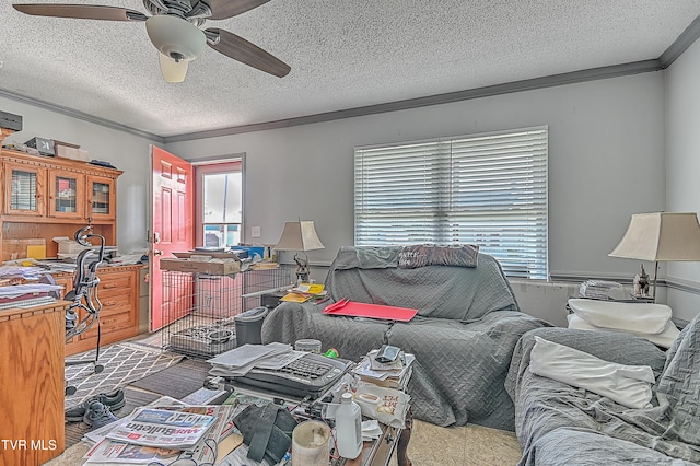 living room featuring a wealth of natural light, crown molding, ceiling fan, and a textured ceiling