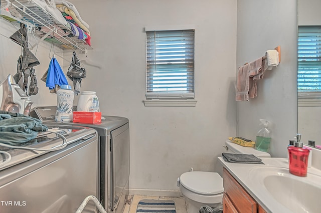 bathroom featuring tile patterned floors, toilet, vanity, and independent washer and dryer