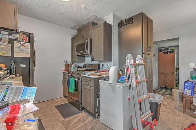 106 W Chilhowie Ave Unit 1, Johnson City, TN 37604 - kitchen with stainless steel appliances, a textured ceiling, and light countertops
