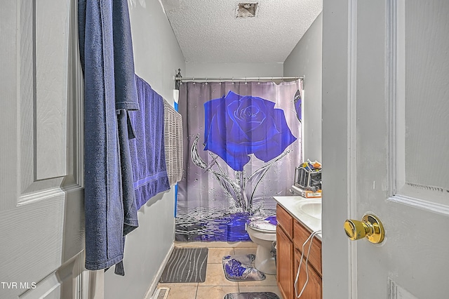 bathroom featuring walk in shower, tile patterned flooring, a textured ceiling, toilet, and vanity