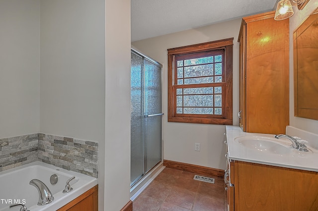 bathroom featuring tile patterned flooring, vanity, a textured ceiling, and independent shower and bath