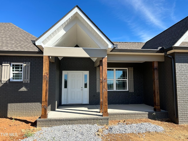 view of exterior entry with a porch