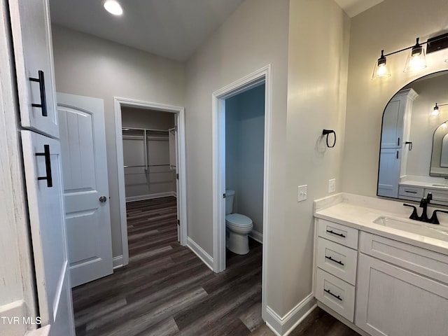 bathroom with vanity, wood-type flooring, and toilet