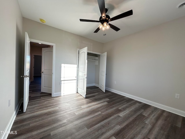 unfurnished bedroom with ceiling fan and dark wood-type flooring