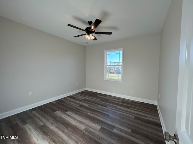 empty room with dark hardwood / wood-style flooring and ceiling fan