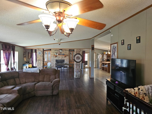 living room featuring ceiling fan with notable chandelier, a textured ceiling, dark hardwood / wood-style flooring, and ornamental molding