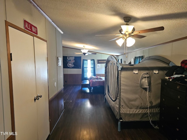 bedroom featuring dark hardwood / wood-style flooring, a textured ceiling, ceiling fan, and lofted ceiling