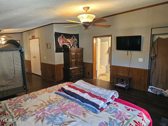 bedroom featuring ceiling fan, crown molding, dark wood-type flooring, and a textured ceiling