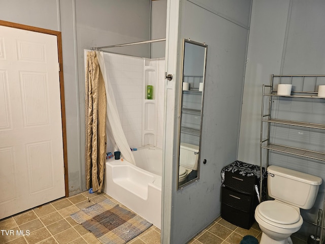 bathroom featuring shower / bath combination with curtain and toilet