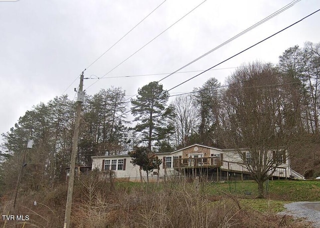 back of house featuring a wooden deck