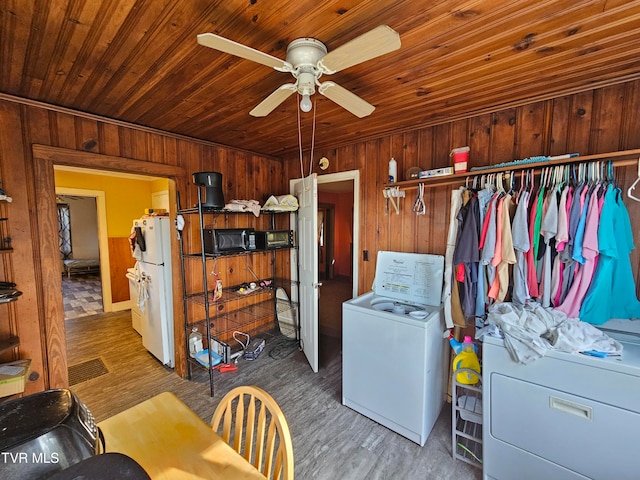 laundry area featuring wooden walls, hardwood / wood-style flooring, and wooden ceiling