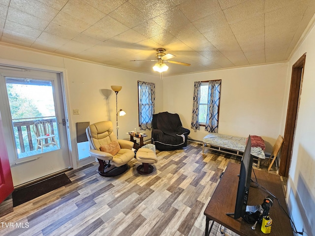 sitting room featuring crown molding, hardwood / wood-style flooring, ceiling fan, and plenty of natural light