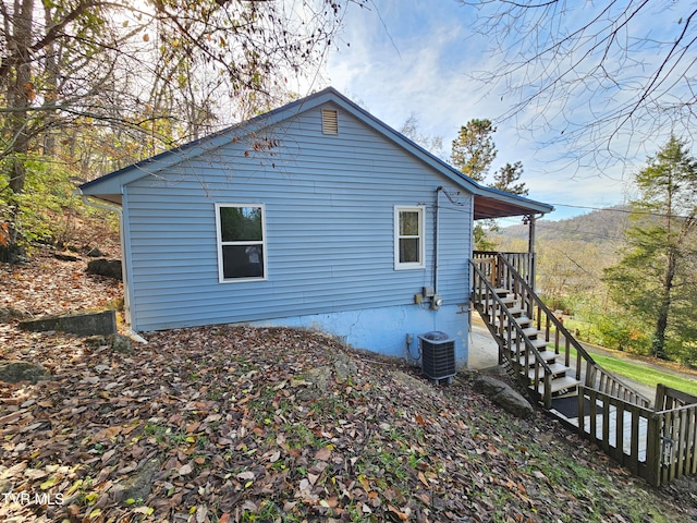 view of side of home featuring central AC