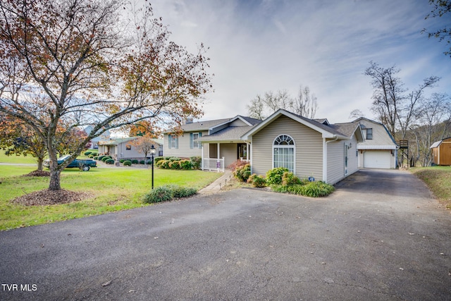 view of front of property with a front yard and a garage