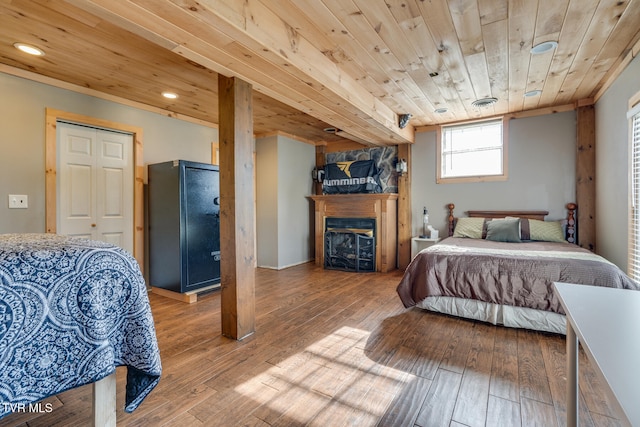 bedroom with hardwood / wood-style floors, a closet, and wooden ceiling