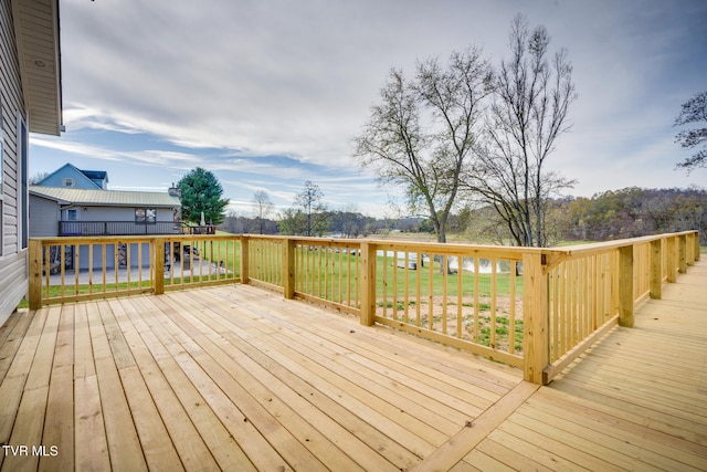 wooden terrace with a yard