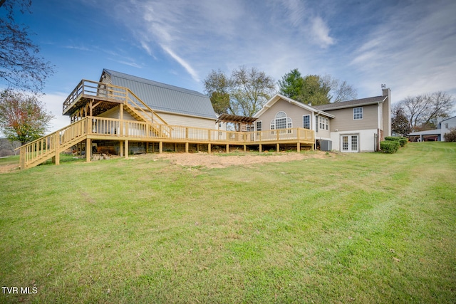 rear view of house with central AC, a yard, and a deck