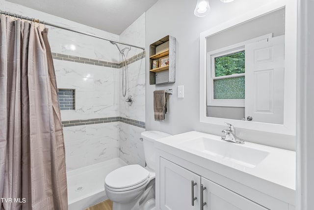 bathroom with vanity, toilet, walk in shower, and a textured ceiling