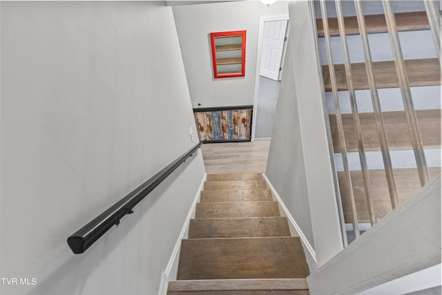 stairway with hardwood / wood-style flooring