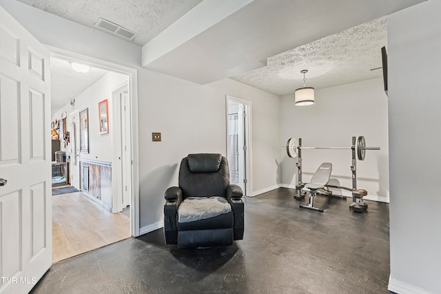 sitting room featuring a textured ceiling