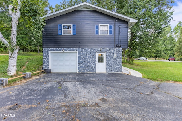 view of home's exterior with a yard and a garage