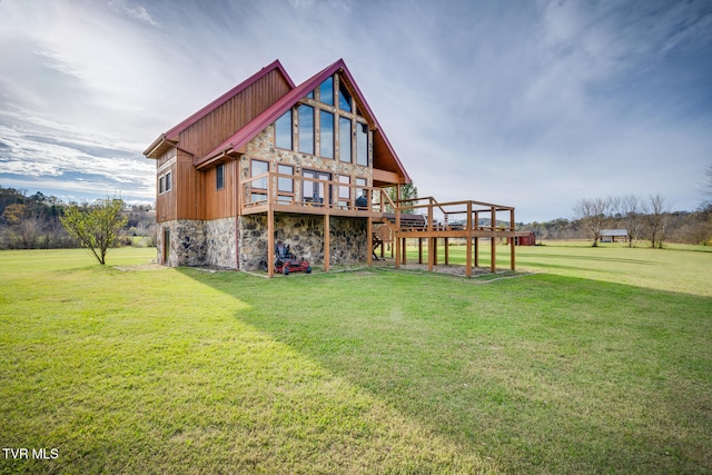 rear view of property with a yard and a deck
