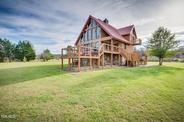 rear view of property with a yard and a deck