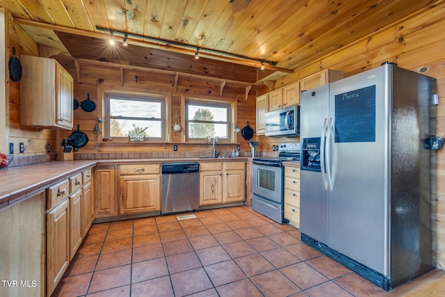 kitchen with light brown cabinets, rail lighting, stainless steel appliances, and wood ceiling