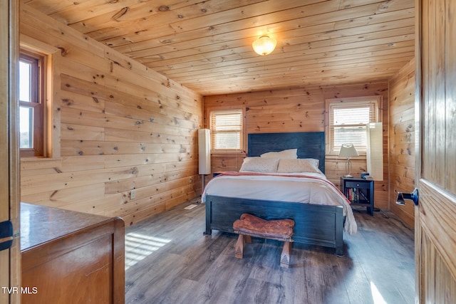 bedroom with wood-type flooring and wooden walls