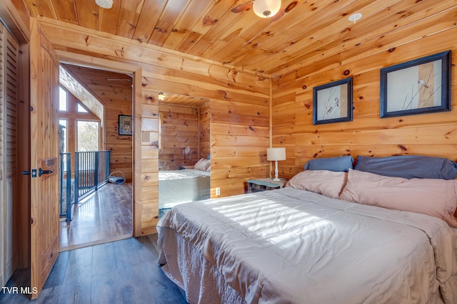 bedroom with wooden ceiling, hardwood / wood-style flooring, and wooden walls