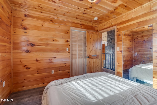 bedroom featuring wood-type flooring, a closet, and wooden walls