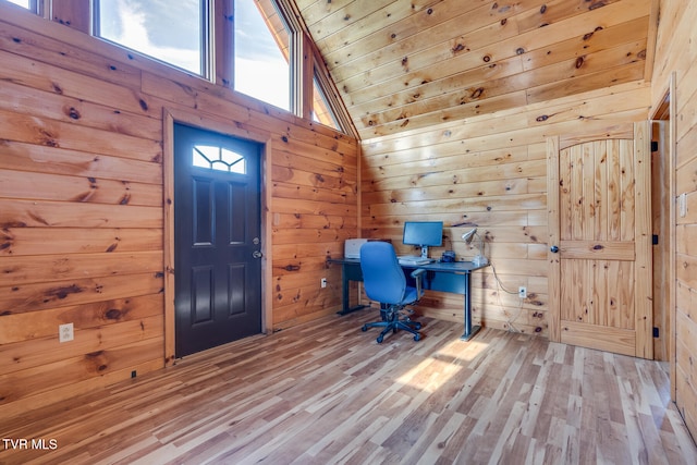 unfurnished office featuring wooden walls, high vaulted ceiling, wood ceiling, and light wood-type flooring