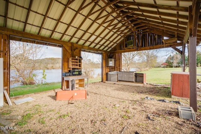 exterior space with a water view and high vaulted ceiling