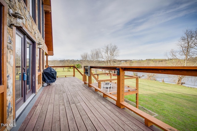 wooden terrace featuring a yard and grilling area