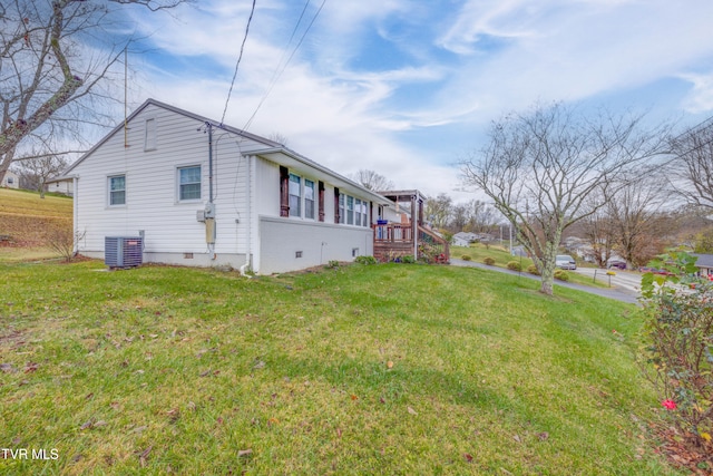 view of property exterior with a lawn, central AC, and a wooden deck