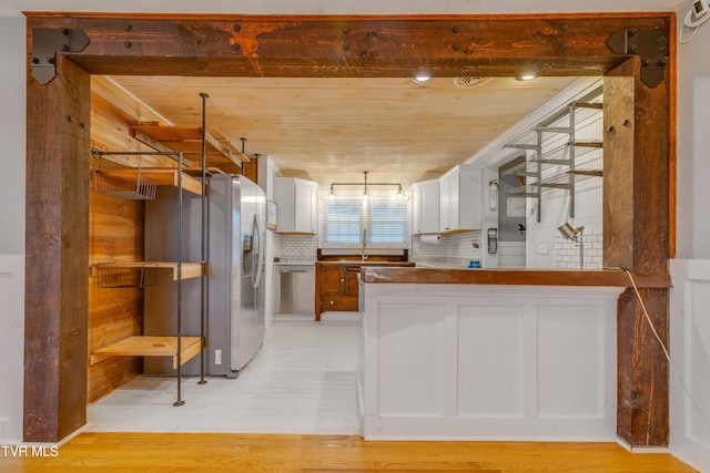 kitchen with white cabinetry, dishwasher, sink, backsplash, and light wood-type flooring