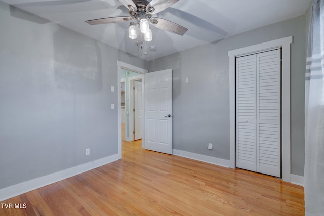 unfurnished bedroom with ceiling fan, light hardwood / wood-style floors, and a closet