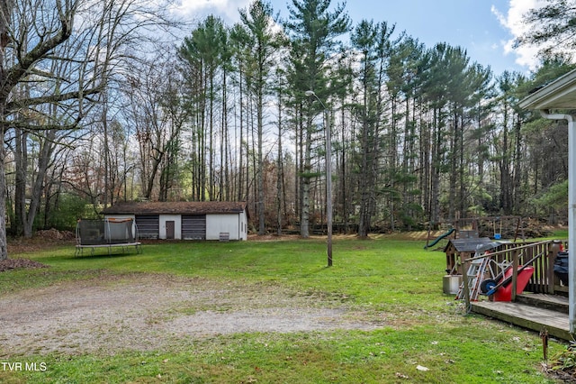 view of yard featuring an outbuilding and a trampoline