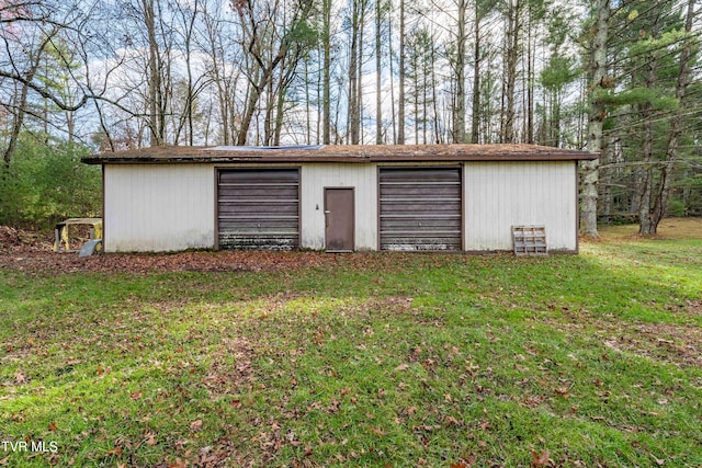 view of outbuilding featuring a lawn