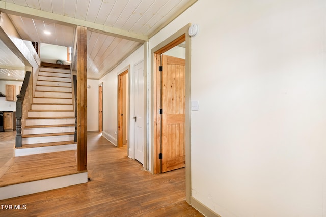 stairway featuring hardwood / wood-style flooring and wood ceiling