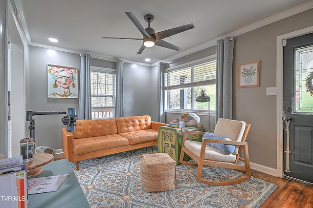 living room featuring crown molding, dark hardwood / wood-style flooring, ceiling fan, and a healthy amount of sunlight