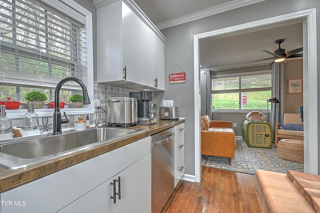 kitchen featuring dishwasher, sink, dark hardwood / wood-style flooring, white cabinets, and ornamental molding