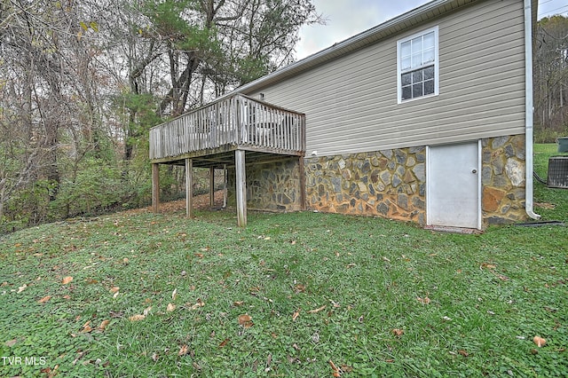 view of yard with central AC unit and a wooden deck